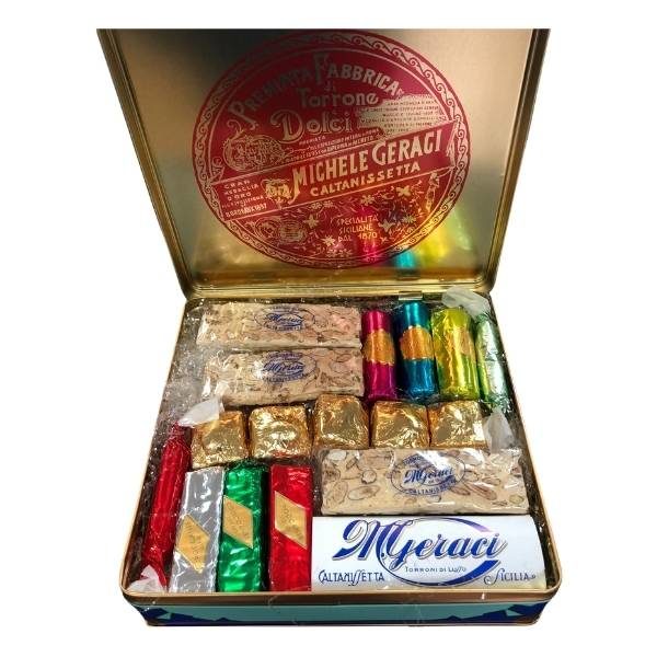 Assorted nougats in metal box - 550gr Assorted nougats in metal box - 550gr was designed in the 1920s of the last century, and from that period reflects the Art Nouveau style. In the 80s it was redesigned, smoothing the corners, and since then it is the ideal container for our nougats, also because in the metal the nougat keeps longer its organoleptic characteristics. Metal packaging containing the assortment of Geraci nougats. 1 pack contains 18 pieces of nougat - 550gr GLUTEN FREE product. The box contains 550 grams of assorted nougats, and in particular: 2 pieces of torrone Bloc 50 gr 1 piece of torrone Umberto 3 pieces of torrone Elena or Crispy 3 pieces of Jolanda nougat or almond cream filling 5 pieces Torrone Pepita 2 pieces of Soft Torroncini 2 pieces of torroncini Splendor. Ingredients Traditional Torrone: Almonds, Honey, glucose syrup, sugar, egg white, pistachios, vanilla. Torrone Fantasy or Covered with Dark Chocolate: Almonds, Honey, glucose syrup, sugar, Egg white, Pistachios, Vanillin, Cocoa paste, Cocoa Butter, Soy Lecithin Emulsifier, Natural Vanilla Aroma. Cocoa minimum 58%. May contain Milk. Allergens: Almonds, Egg white, Pistachios, Soy.